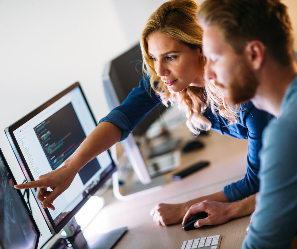 Software engineers working on project and programming in company